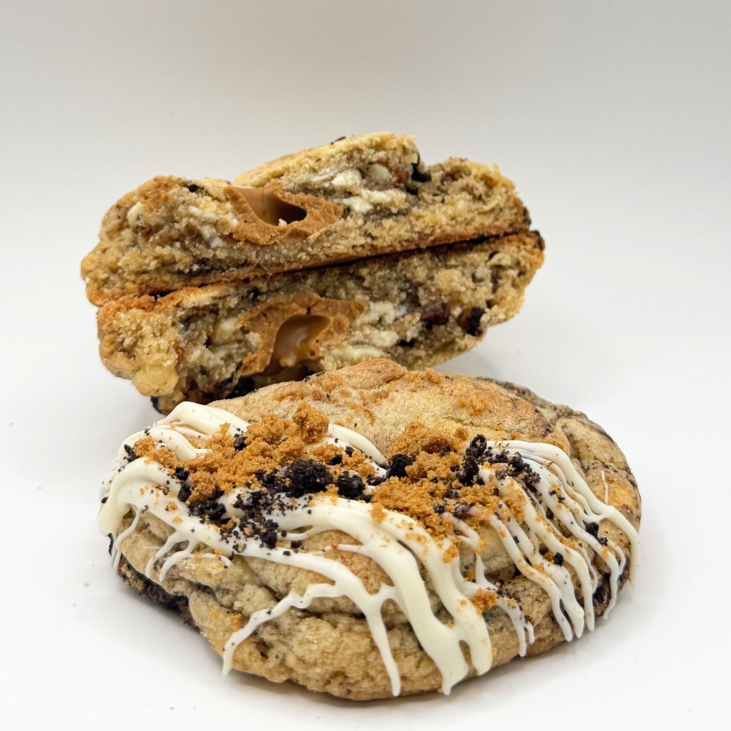 Cookie with white drizzle and chocolate chips on a white background