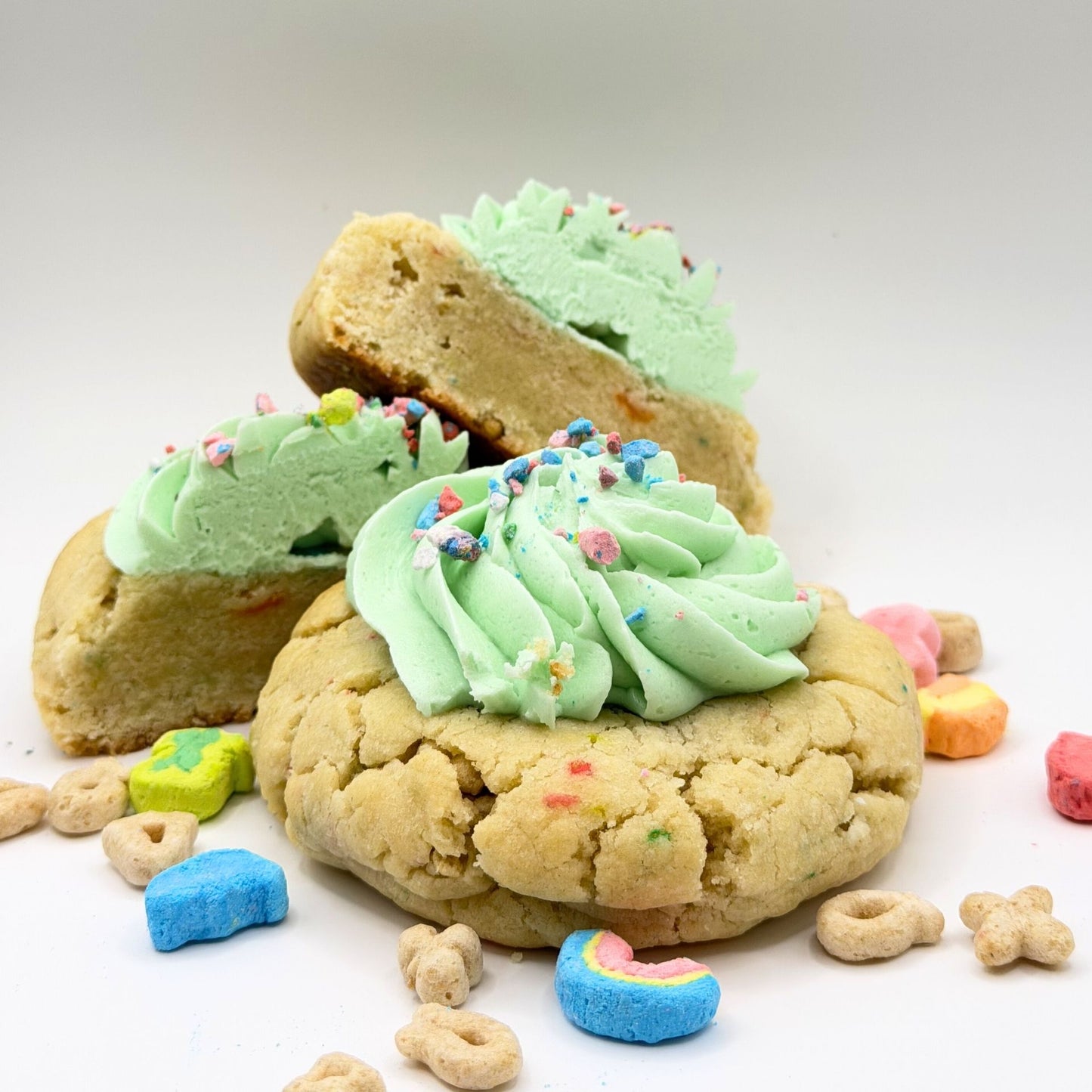 Cookies with green frosting and sprinkles on a white background