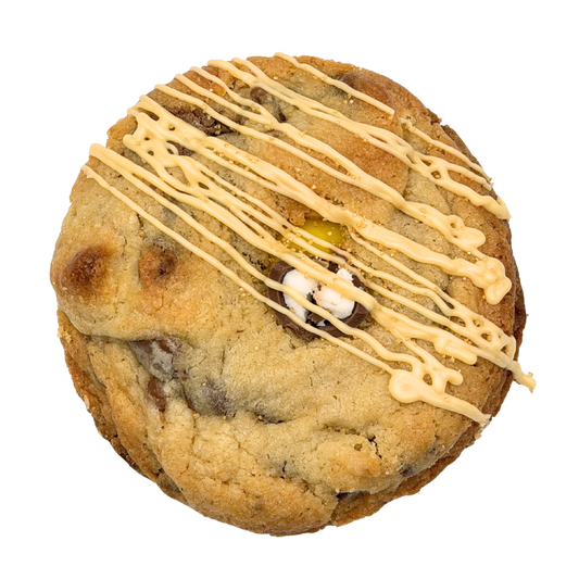 Cookie with white chocolate drizzle on a white background