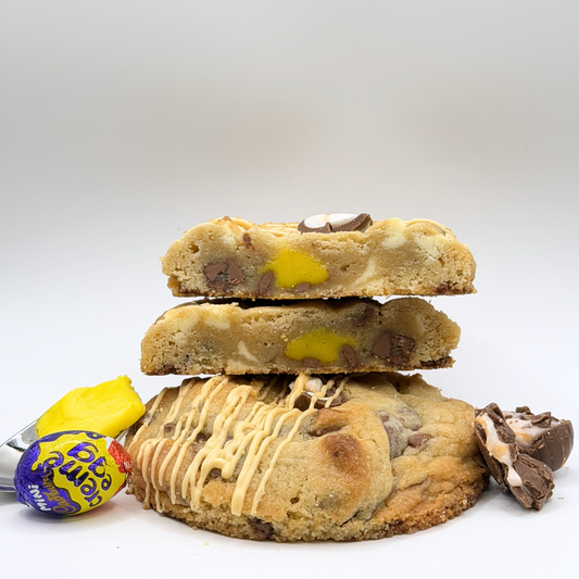 Stack of cookies with candy pieces on a white background